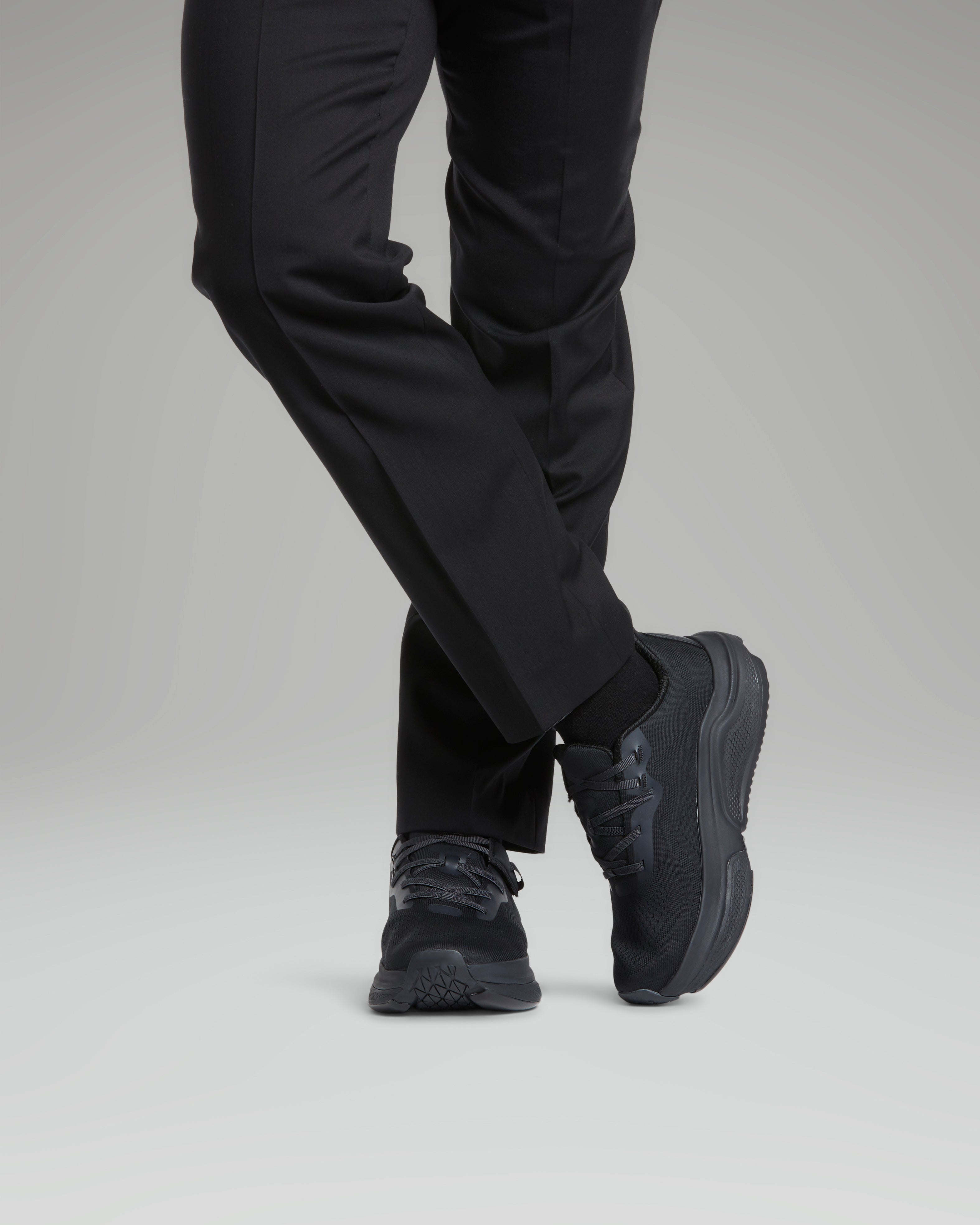 Man wearing black pants and black shoes