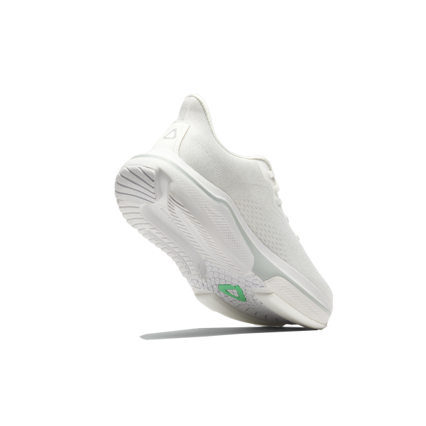 White athletic shoe with a green logo on a white background