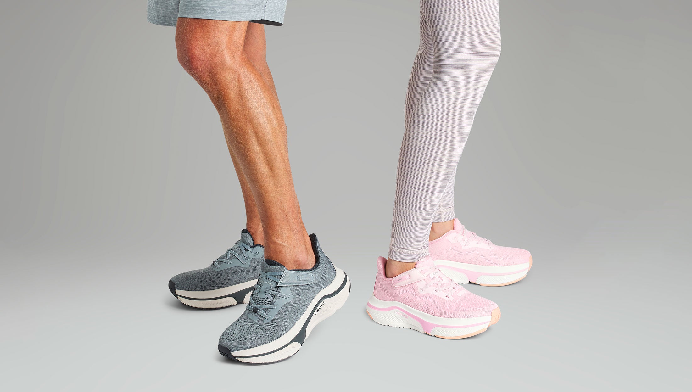 Two pairs of sneakers, one gray and one pink, on a neutral background.