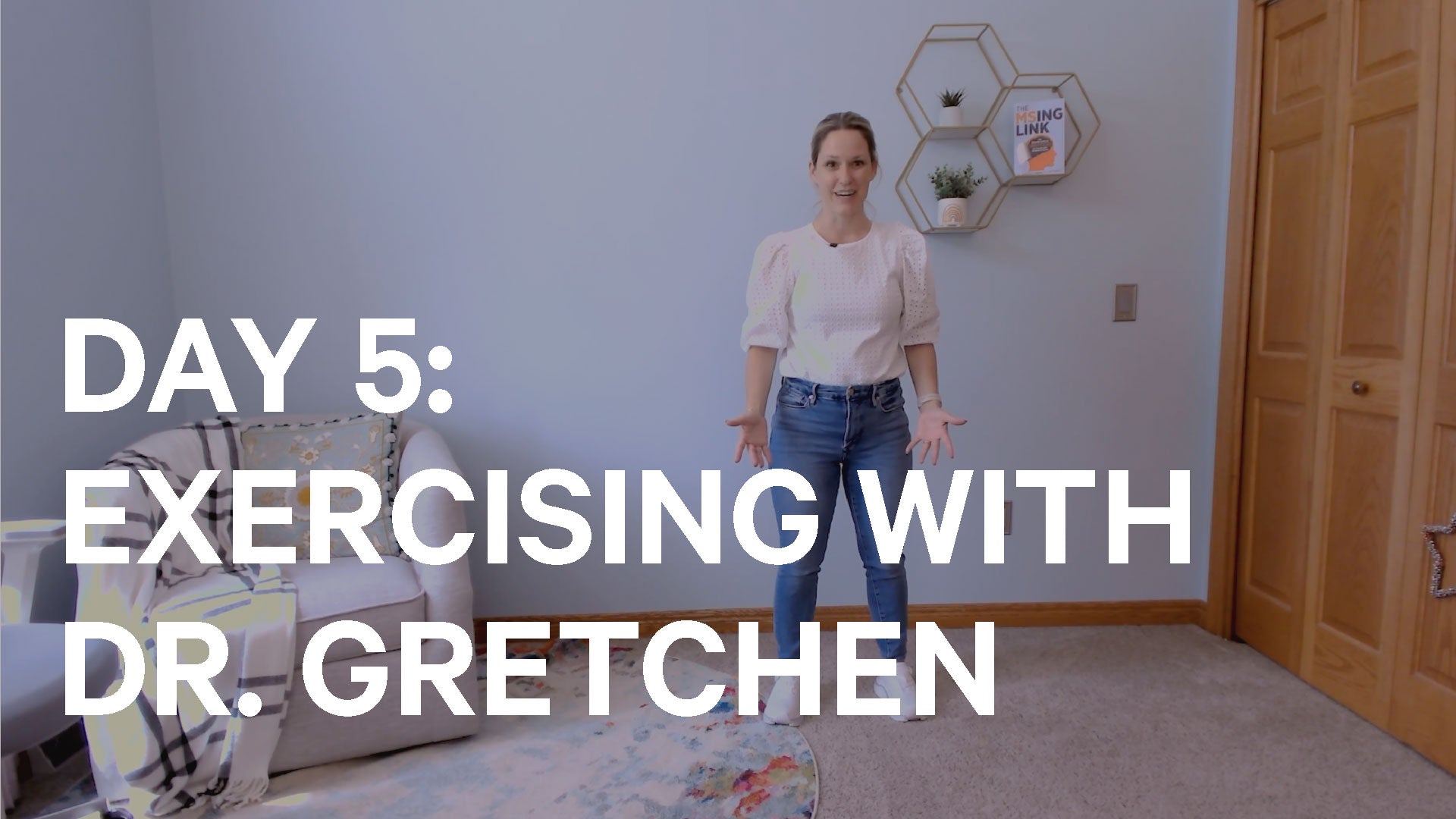 Woman standing in a room with text 'Day 5: Exercising with Dr. Gretchen' on a light blue wall.