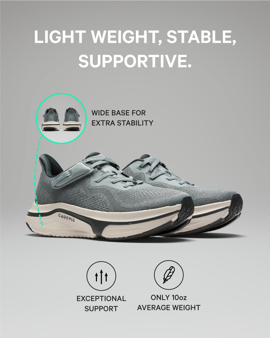 Gray athletic shoe with text highlighting features on a gray background
