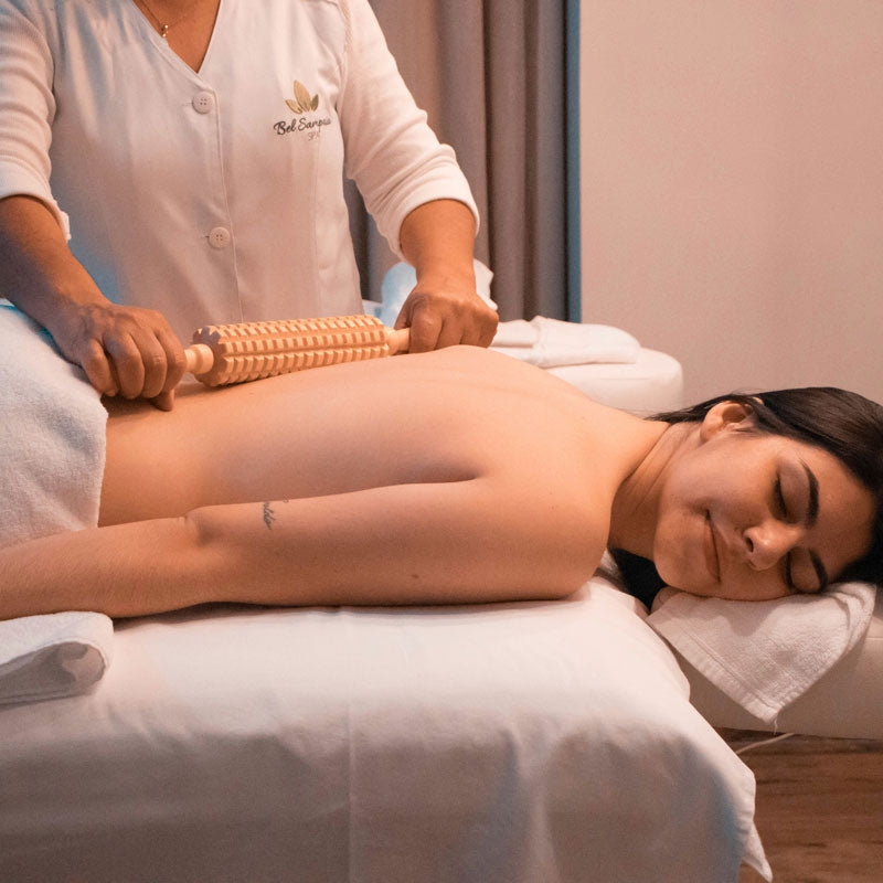 Person receiving a massage with a roller at a spa.