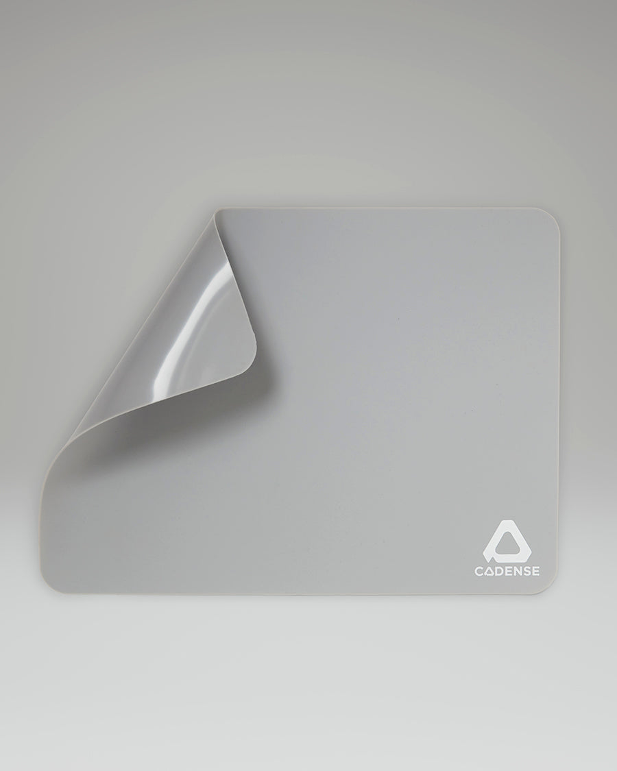 Gray mat with Cadence logo on a gray background