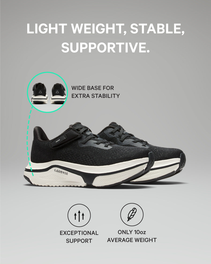 Black athletic shoes with text highlighting features on a gray background