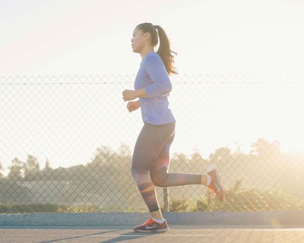 Woman running on a track with a blurred background
