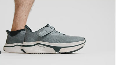 Putting on gray shoe