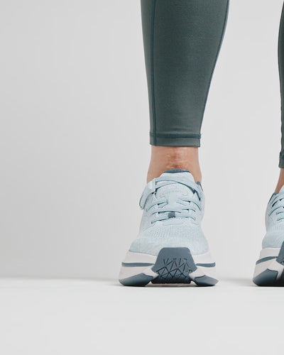 Woman testing the variable friction technology of a Cadense adaptive sneaker